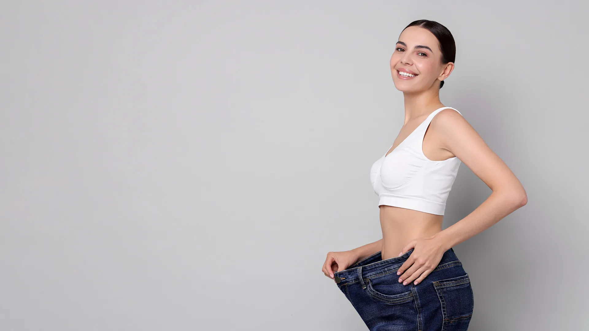 Woman celebrating weight loss results at iCRYO SouthPark Medical Weight Loss program