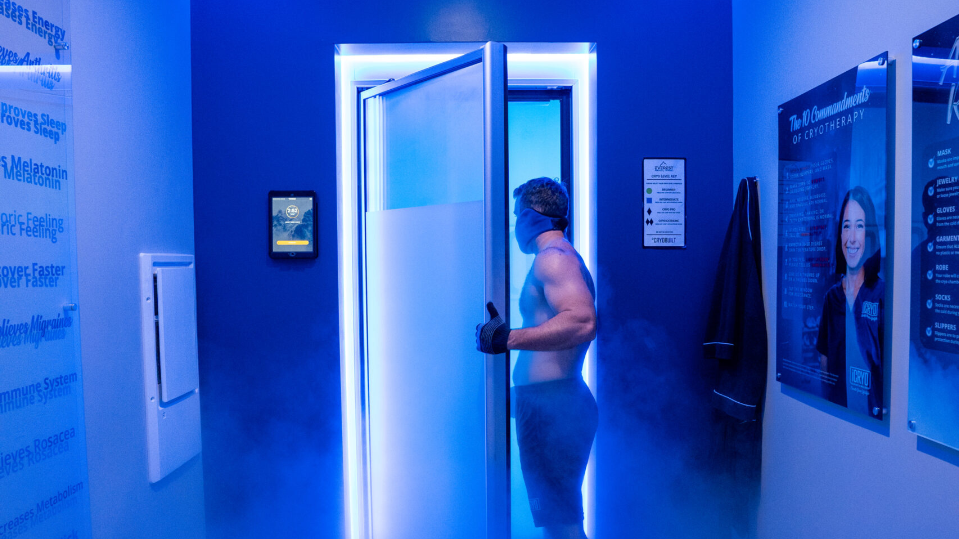 Person experiencing whole body cryotherapy session with blue nitrogen vapor